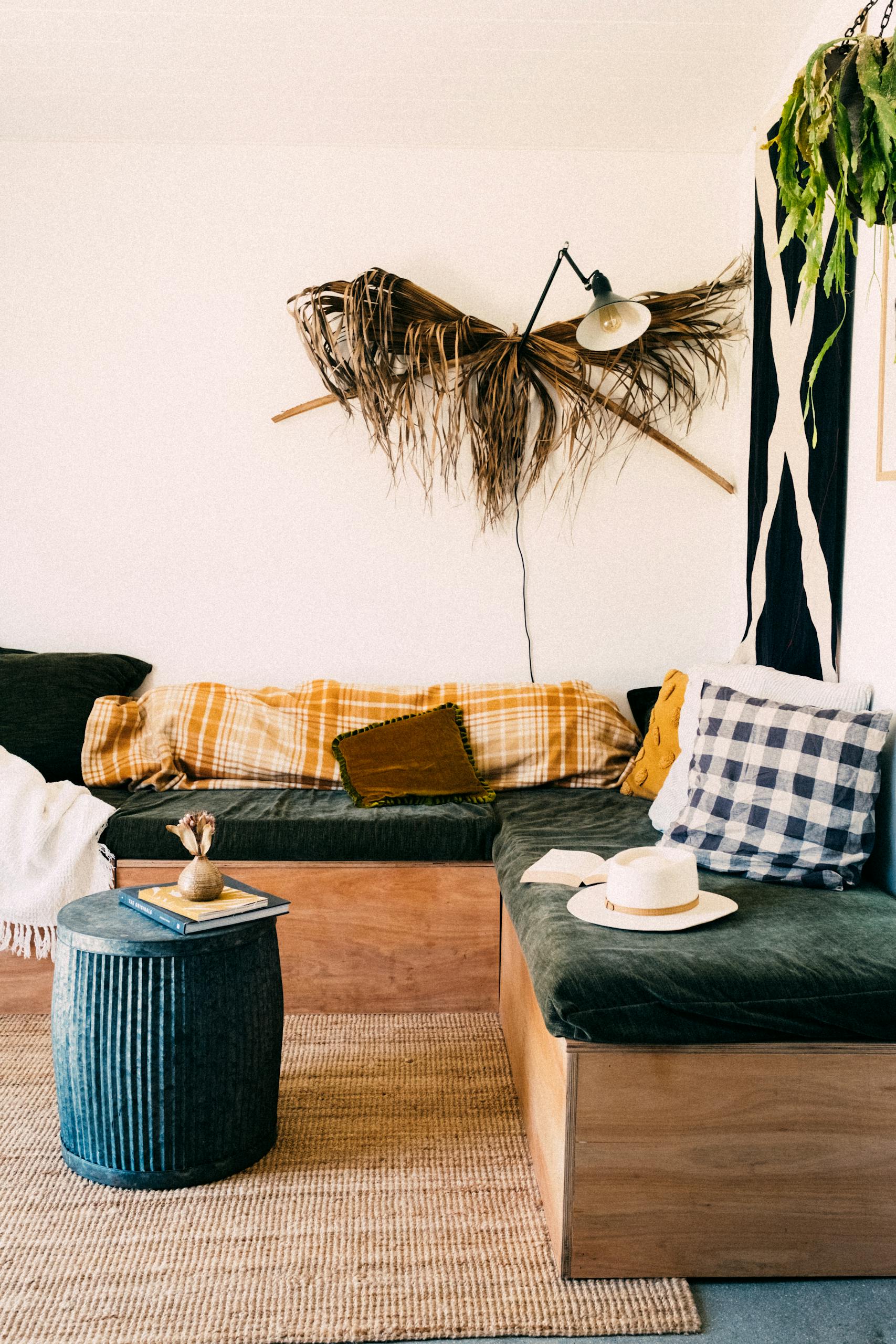 Stylish bohemian living room with plants, cozy seating, and unique decor.